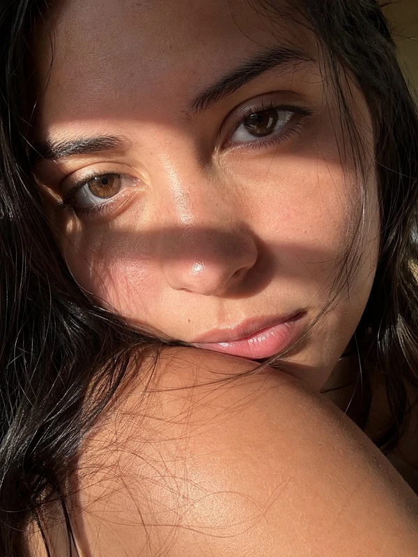 Close portrait of a woman in warm striped sunlight